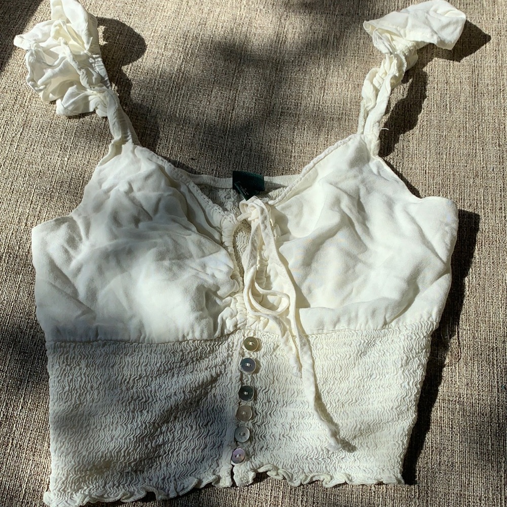 Super cute crop top w/ buttons and ruffle sleeves.